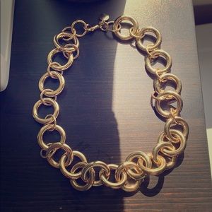 Short, chunky, gold necklace.